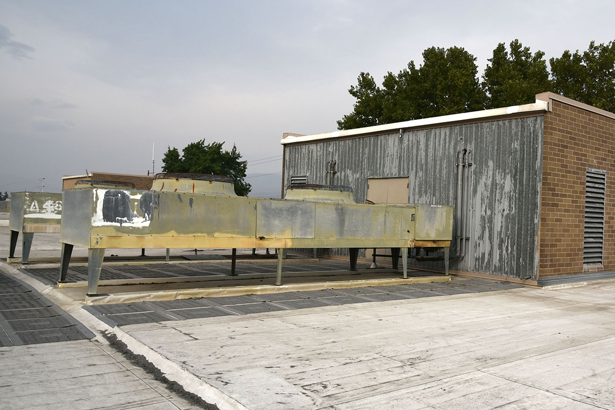 Severely corroded rooftop HVAC units on Wenatchee High School, original to the 1972 building and long past their design lifespan