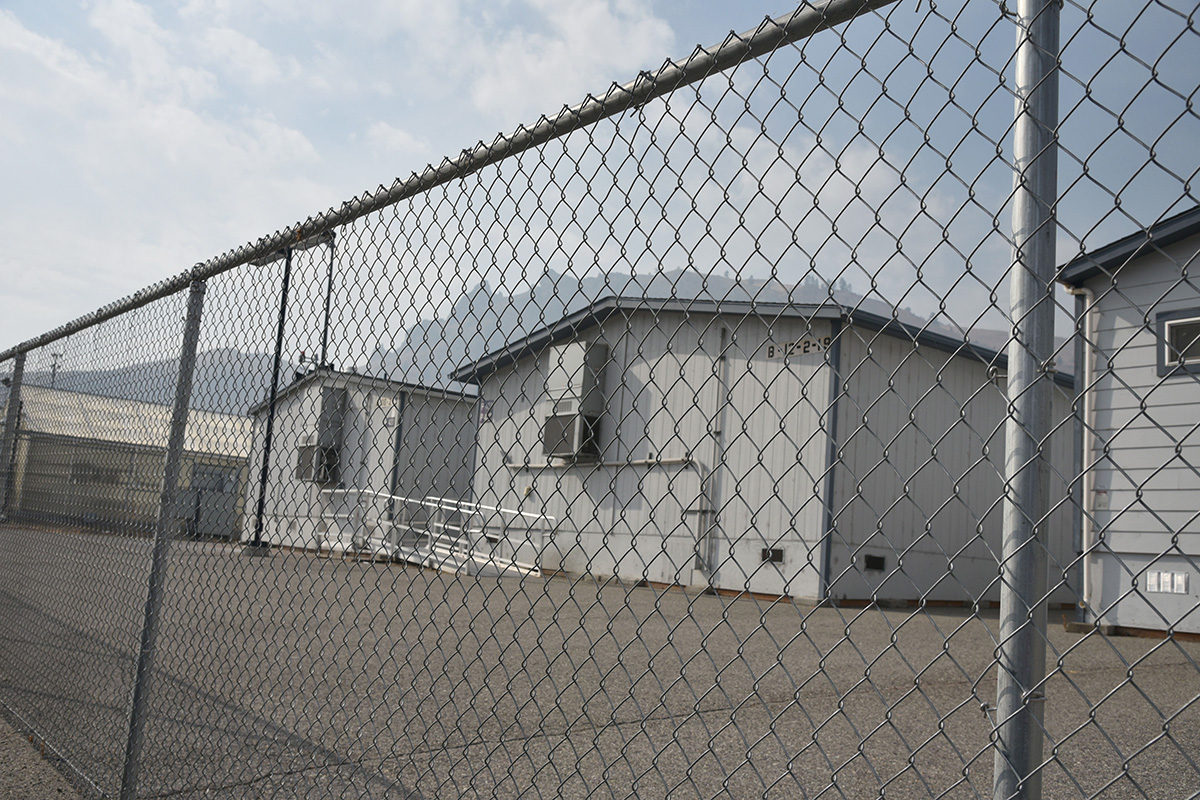Portable classroom buildings behind a chain-link fence at Wenatchee High School, used to accommodate student overcrowding beyond the building's 1,400-student design capacity